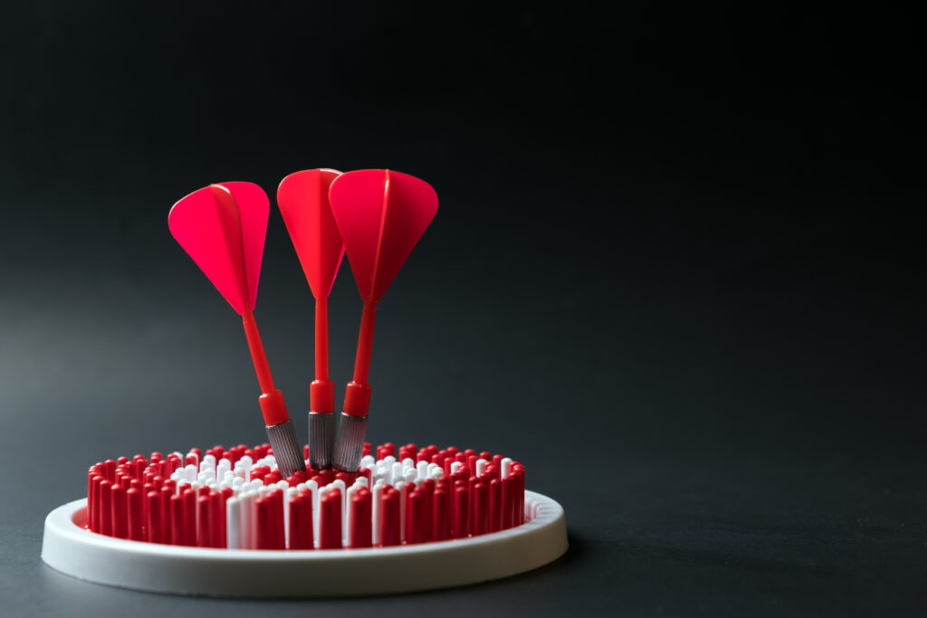 Three red darts on a target